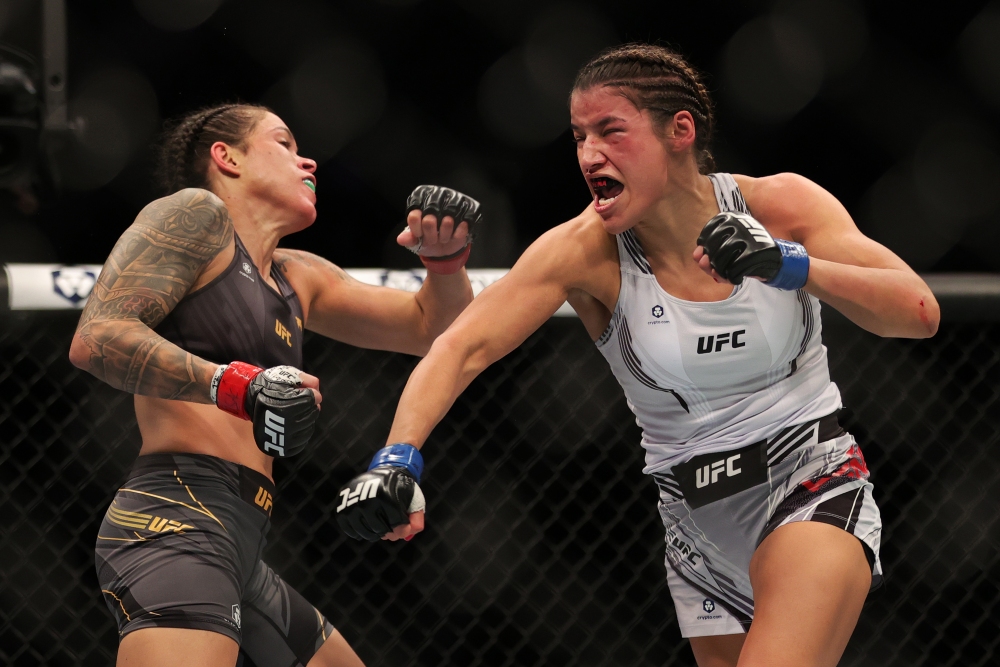 Amanda Nunes absorbs a blow from Julianna Pena